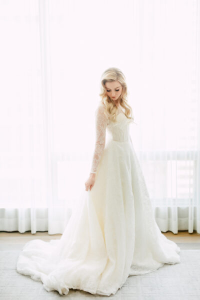 Blonde bride in modest long sleeve wedding dress at Four Seasons Toronto